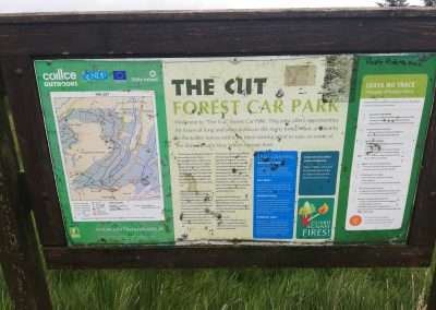 A sign post with map and details of a location call the Cut.